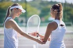 Tennis, trainer and professional female helping a friend with her racket on an outdoor sports court. Supportive, caring and happy woman or team player assisting her partner for balance in the sport.