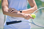 Sport, active and male tennis player with a racket and ball standing on a court ready for a match. Closeup of a fit, strong and professional man with equipment touching a injury on his arm.