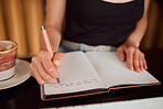 Woman writing thoughts in notebook, taking notes and doing morning journal routine at home from above. Top view of female writer or author being creative, expressing feeling and planning in book
