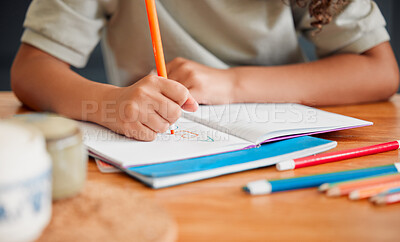 Buy stock photo Child coloring, drawing and doing art activity in book in home living room while having fun, enjoying and feeling playful. Closeup hands of small, little and young creative girl expressing with color