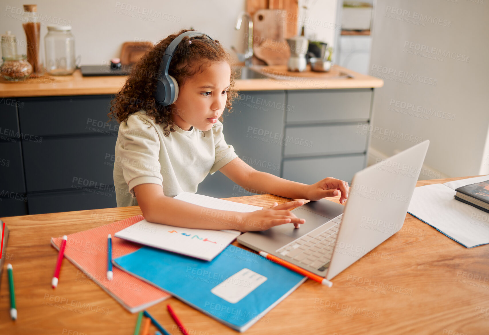 Buy stock photo Child education, learning and listening with laptop and headphones for online interactive activity or distance teaching lesson at home. A little, smart and modern student busy with an assignment test