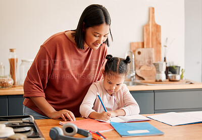 Buy stock photo Mother teaching daughter, doing homework at kitchen table at home, bonding while learning together. Loving parent helping her child with a school project or task. Autistic child enjoying homeschool 