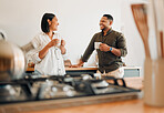  Happy, loving and romantic couple bonding, standing and laughingat home in the kitchen. Husband and wife talking, affection and enjoying feeling carefree while having a cup of coffee in the morning