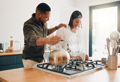 Buy stock photo Loving couple having coffee or tea, relaxed and carefree while bonding in a kitchen at home. Caring husband being affectionate, talking and enjoying their relationship and quiet morning with his wife