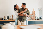Happy, hugging and romantic couple bonding and feeling united, supported and in love. Smiling, cheerful and relaxed woman holding man in home kitchen during morning coffee routine and honeymoon break