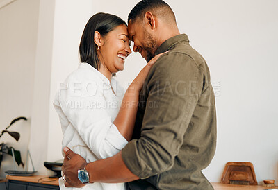 Buy stock photo Romantic, laughing and hugging couple bonding, spending time together or feeling in love at home. Happy, smiling and embracing man and woman sharing intimate moment with touching foreheads in lounge
