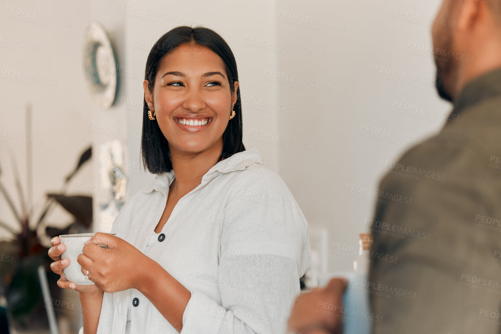 Buy stock photo Woman drinking coffee, having conversation and bonding with her husband at home. Smiling, happy and relaxed wife enjoying quality time, romantic and peaceful moment as a couple in loving relationship