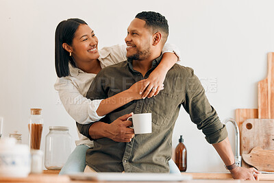 Buy stock photo Happy, coffee and loving couple bonding and having fun while spending time together at home. Smiling, in love and carefree couple hugging and sharing a romantic moment while enjoying the weekend