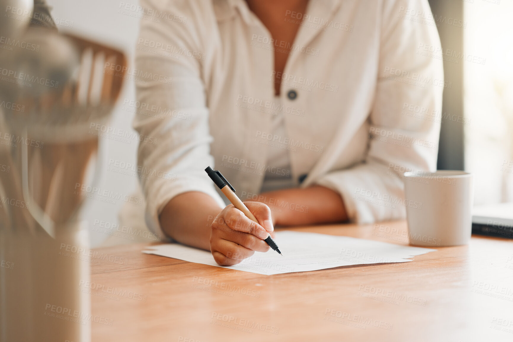 Buy stock photo Writing, paperwork and contract with a woman holding a pen and filling out an application form in her kitchen at home. Insurance, tax and accounting while managing finance and the household budget
