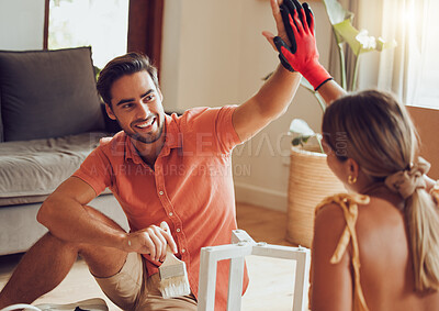 Buy stock photo Couple high five for motivation, success and support after a home improvement and maintenance job. Young smiling partners happy and excited painting and sitting on a living room floor doing diy