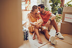 Romance, fun and an intimate moment between a couple moving into a new apartment. Young lovers being affectionate, flirting and enjoying a conversation. Husband and wife taking a break from unpacking