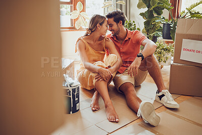 Buy stock photo Romance, fun and an intimate moment between a couple moving into a new home. Young lovers being affectionate, flirting and enjoying a conversation. Husband and wife taking a break from unpacking
