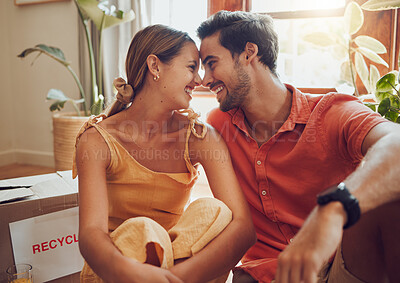 Buy stock photo Happy and in love couple sitting together, bonding and spending quality time in a new apartment, flat or house. Homeowner, loving man and woman relax, care free and enjoy a day inside with a smile