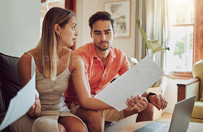 Buy stock photo Unhappy, stressed and upset couple paying bills or debt online on with a laptop at home getting angry, planning budget. Young man and woman having a dispute over finance, savings and increasing tax