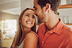 Couple, smiling and in love having a lovely romantic moment in the kitchen at home. Man and woman spending affectionate free time together, happy and bonding with embraced happiness.
