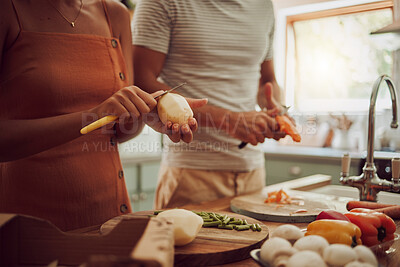 Buy stock photo Health, diet and food of a couple cooking a meal together for lunch in the kitchen at home. Man and woman in a relationship working as a team to cook fresh organic vegetables for healthy nutrition.