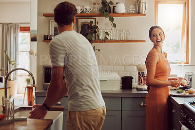 Buy stock photo Couple cooking food, household cleaning or food preparation together in their kitchen at home. Laughing, bonding and caring husband and wife helping each other prepare supper, lunch or meal