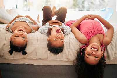 Buy stock photo Silly kids playing upside down on bed enjoy and having fun together in parents bedroom. Happy children or siblings bonding and enjoying childhood together at cozy, warm and comfortable family home