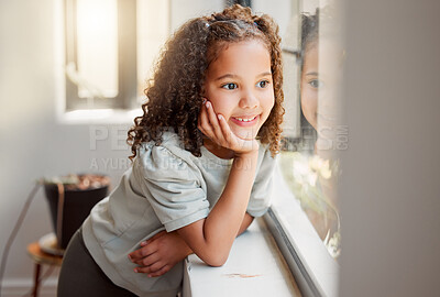 Buy stock photo Little girl dreaming of playing outside in the sun after lockdown, smiling and looking out of a window. Small, cute happy female child waiting, thinking and daydreaming with her hand on her chin