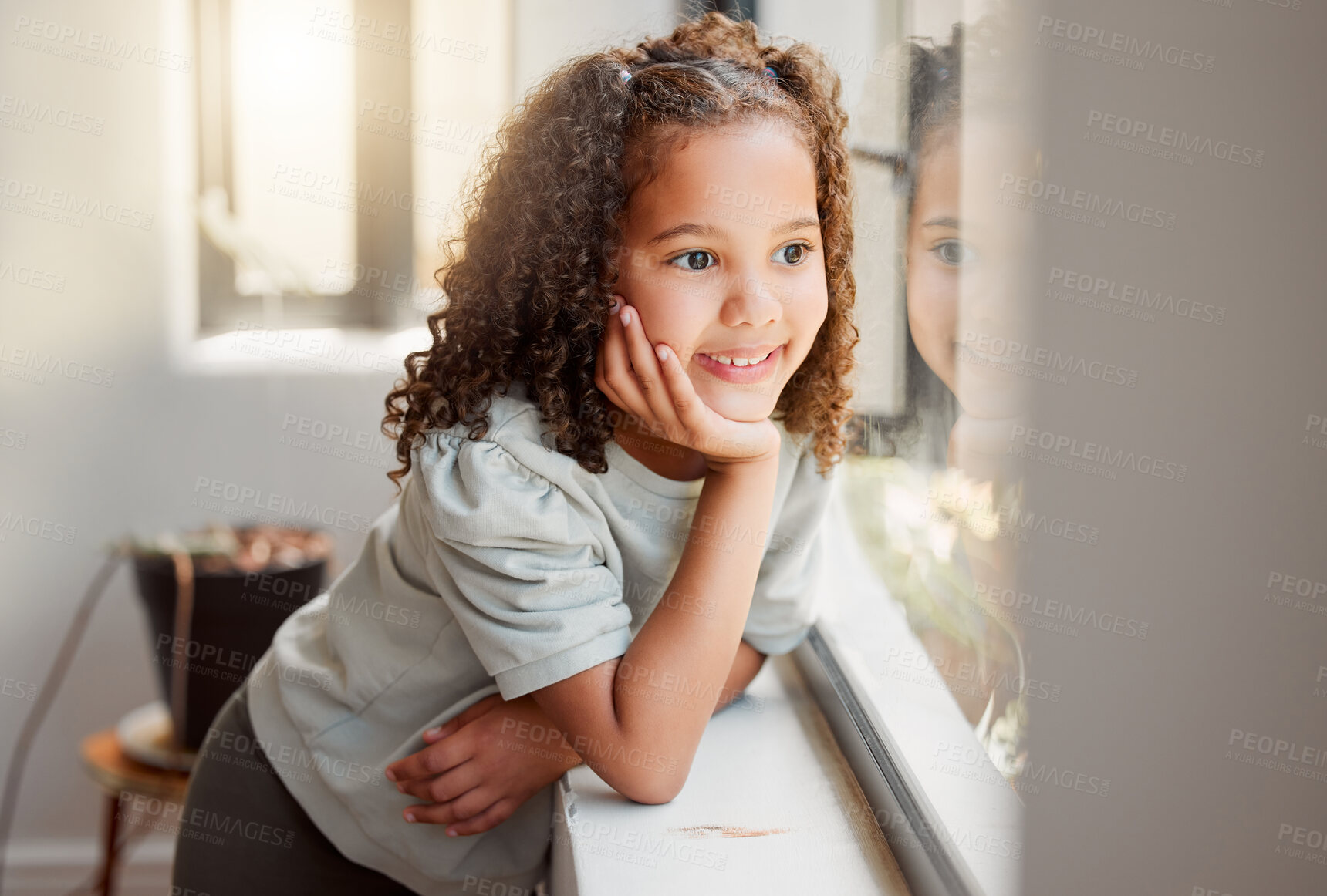 Buy stock photo Little girl dreaming of playing outside in the sun after lockdown, smiling and looking out of a window. Small, cute happy female child waiting, thinking and daydreaming with her hand on her chin