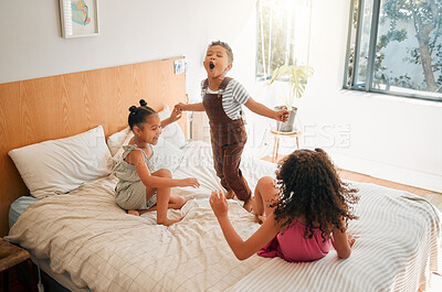 Buy stock photo Children, fun and energy by playing siblings jumping, bonding and enjoying a game on bed at home together. Kids laughing and having fun, sharing playful moments of childhood, celebrate free weekend 