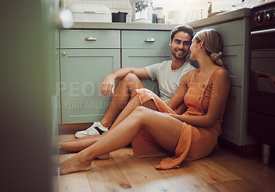 Buy stock photo Couple, in love and on kitchen floor looking into their eyes on luxury real estate. Man, woman and communication and a conversation in a new home, house or room before breakfast with family.
