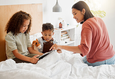 Buy stock photo Mother and children browsing a digital tablet in the bed at home, bonding and learning to use technology. Family on the internet online to play games and learn from educational apps or website
