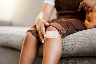 Buy stock photo Child with plaster or bandaid, injured and hurt by accident while playing a sport, exercise or outside closeup. Kid with a medical bandage after help on wound, injury or scratch on skin, knee or leg