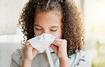 Sick, cleaning nose with tissue and tired girl kid suffering from flu virus, cold or covid at home. Closeup of a young child with a bad allergy or coronavirus sneezing with a sinus headache 