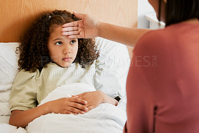 Buy stock photo Concerned, anxious and unwell girl suffering with cold or flu while her mother checks her temperature at home. Worried parent caring for her sick child, feeling for fever while worrying about corona