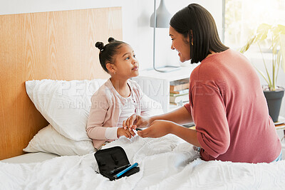 Buy stock photo Care, health and diabetic girl talking and bonding with mother, learning to balance her illness. Loving parent caring for her child, teaching her diabetes awareness, doing routine insulin treatment