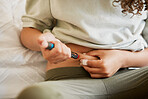 Diabetes, diabetic or woman with a chronic disease injecting herself with insulin treatment at home. Closeup of a female taking glucose medication or medicine to control blood sugar levels