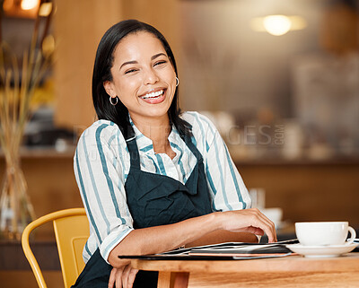 Buy stock photo Coffee shop owner looking proud and happy while doing paperwork and having coffee break. Young business woman checking stock, orders and inventory, enjoying her career. Positive lady managing a cafe