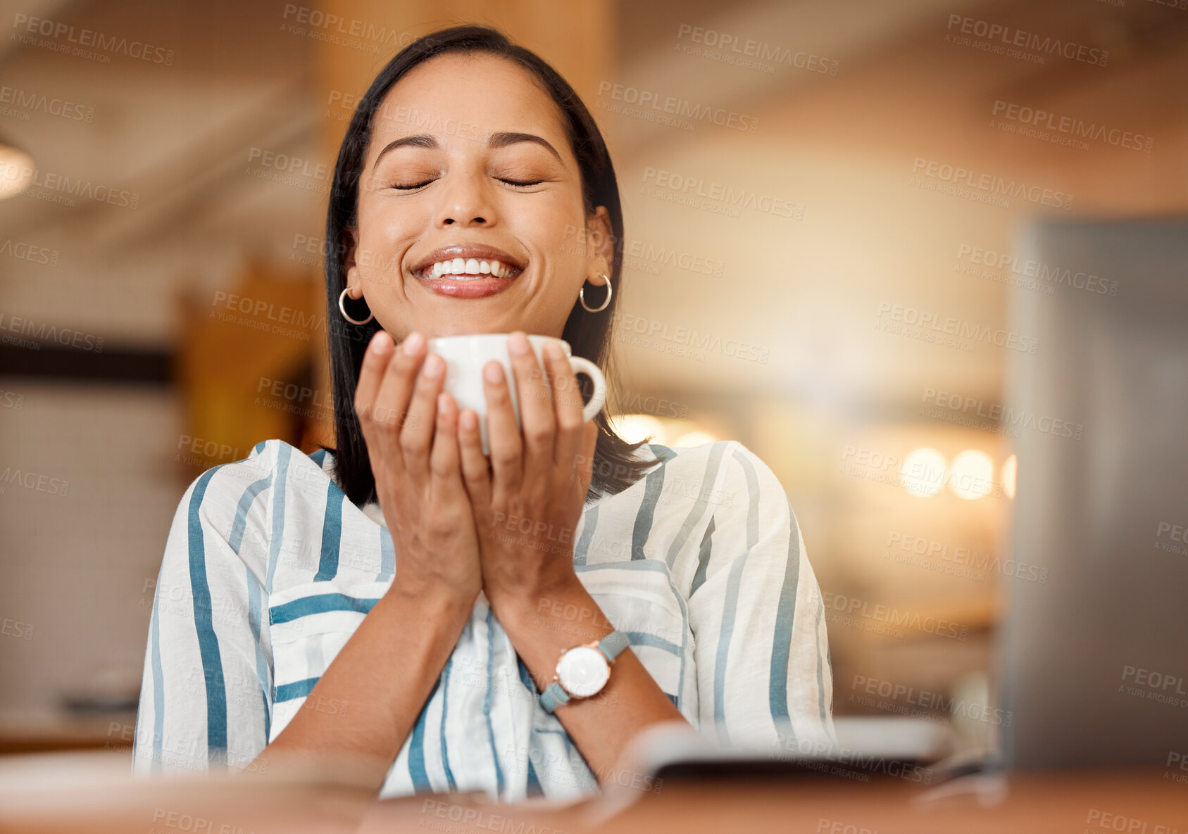 Buy stock photo Smiling, cheerful and casual young businesswoman enjoying a cup of coffee in a restaurant or cafe on her lunch break. Portrait of happy customer drinking her morning caffeine or tea beverage 