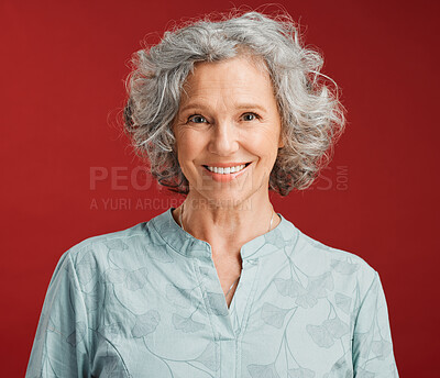 Buy stock photo Portrait of senior, happy and cheerful woman standing against a red studio background. Mature woman with healthy, white and clean teeth showing oral and dental health with a friendly bright smile