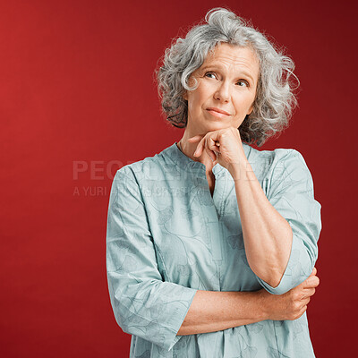 Buy stock photo Mature woman thinking, making a decision or choice about what to wear with copy space. Confused senior caucasian female lost in her thoughts. Serious and uncertain retired lady choosing an option.