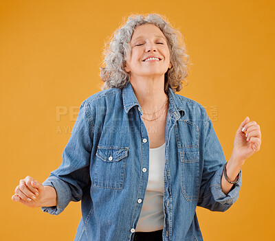 Buy stock photo Smiling mature woman celebrating, dancing and being carefree, happy and excited for retirement. Portrait of positive, trendy and funky positive senior lady free spirit, dance and having fun in studio