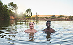 Vacation, friends and having fun while swimming in a lake and enjoying summer. Portrait of happy and diverse guys smiling while enjoying the water and friendship on their holiday and nature travel
