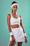 Fit, athlete or female tennis player or serious sportswoman ready for competition or a match. Portrait of an African American athletic female in sportswear against a green studio background