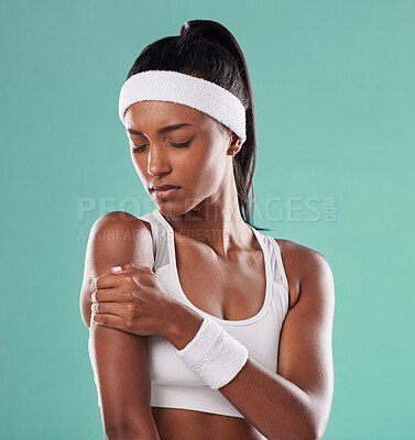 Buy stock photo Tennis player with sports injury, hurt or pain in her arm after practice against green studio background. Professional female athlete suffering muscle strain, accident and inflammation on her body