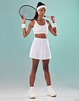 Black woman, tennis player or sports athlete training for a game. Motivation, fitness and a focus on health, exercise and wellness. A healthy African girl standing with a racket in a studio portrait.