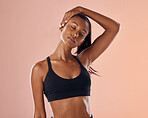 Slim, fit and stretching exercise of a woman feeling confident about her body and health against a pink studio background. Sporty and active woman staying healthy and in shape during a workout