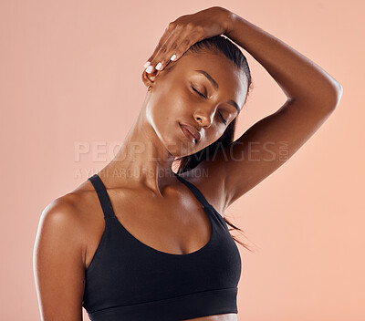 Fitness, wellness and sports woman stretching sore neck, pain and injury after studio workout, exercise or training. Motivation, active and athletic health model getting ready against pink background