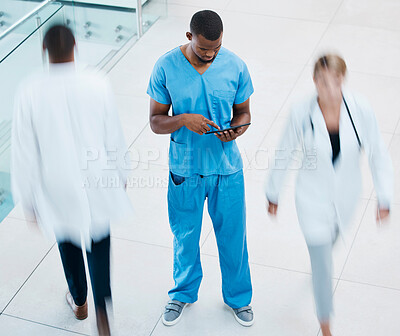 Buy stock photo Healthcare, doctors and a nurse on a tablet, in a hospital or clinic corridor. Medical worker consulting patients chart online before surgery. Management, teamwork and innovation to help health care.