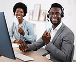 Customer service agents working on computer, helping people online and giving support while sitting together at work. Portrait of African call center agents wearing face mask to protect from covid
