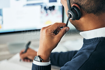 Buy stock photo Call center, customer service and agent assisting online customer with a headset and taking notes. Closeup of a male financial consultant or telemarketer working on a computer to consult clients.