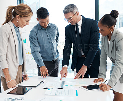 Buy stock photo Finance, data and business people working on a graph in a modern office. Documents, teamwork and a multiracial group discuss project strategy with ceo or leader in a meeting in the boardroom. 
