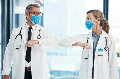 Buy stock photo Elbow greeting, doctors and medical healthcare workers with covid 19 virus safety masks in a hospital portrait. Life, emergency and wellness social distancing to stay safe. Employee ready for service