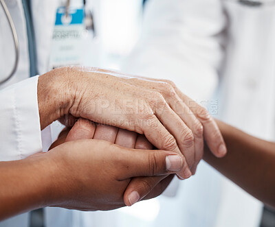 Buy stock photo Doctor, holding a patient's hands and comforting them after the loss of a loved one at a hospital. Medical consultant, reassuring sick person after a cancer diagnosis and giving support or treatment.
