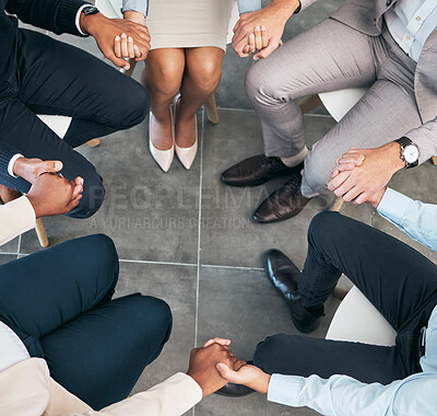 Buy stock photo Support, teamwork and unity of business group holding hands and sitting in a circle doing a team building plan. People, team or diverse employees united in trust during a meeting in an office